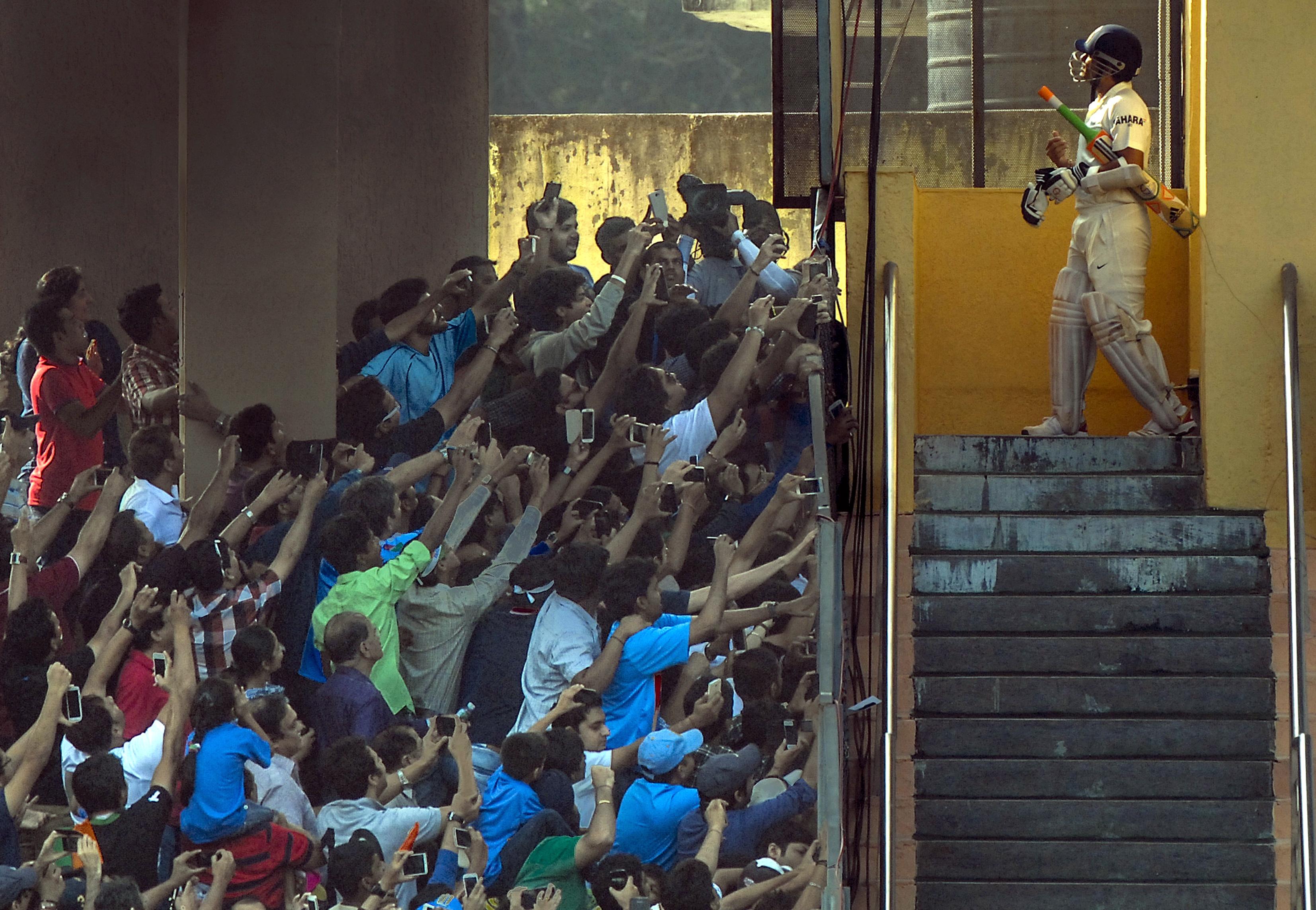 Sachin Tendulkar walking out of the Wankhede Stadium dressing room to resume his innings on the second day of the India vs West Indies Test. This was the day, the cricket world watched Sachin bat for the last time in India colours. The enthusiasm of the crowd with their mobile phone camera shows reverence and respect for the cricketing icon, who was playing his 200th Test at his home ground in Mumbai on 15/11/2013.
Pic/Atul Kamble